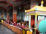 Pokhara Karma Dubgyu Chokhorling Monastery 09 Monks In The Main Prayer Hall With Drum and Painted Pillars and Walls